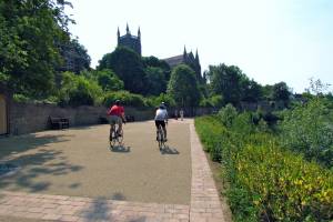 Two people on bikes next to the riverside in Worcester
