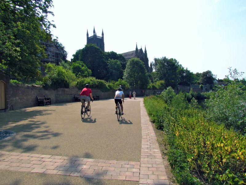 Two people on bikes next to the riverside in Worcester
