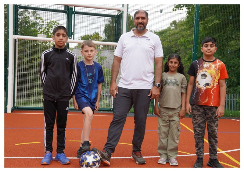 Four children and councillor Jabba Riaz at the multi-use games area at the Horizon Hub