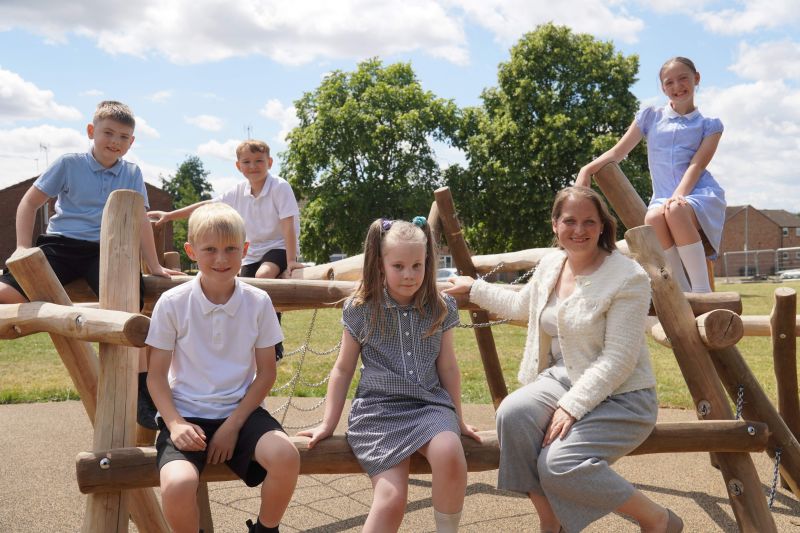 Councillor Hannah Cooper with pupils from Cranham Primary School on the new play equipment