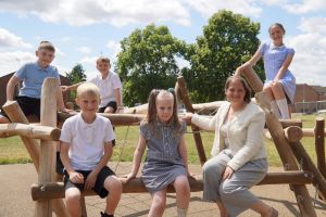 Councillor Hannah Cooper with pupils from Cranham Primary School on the new play equipment
