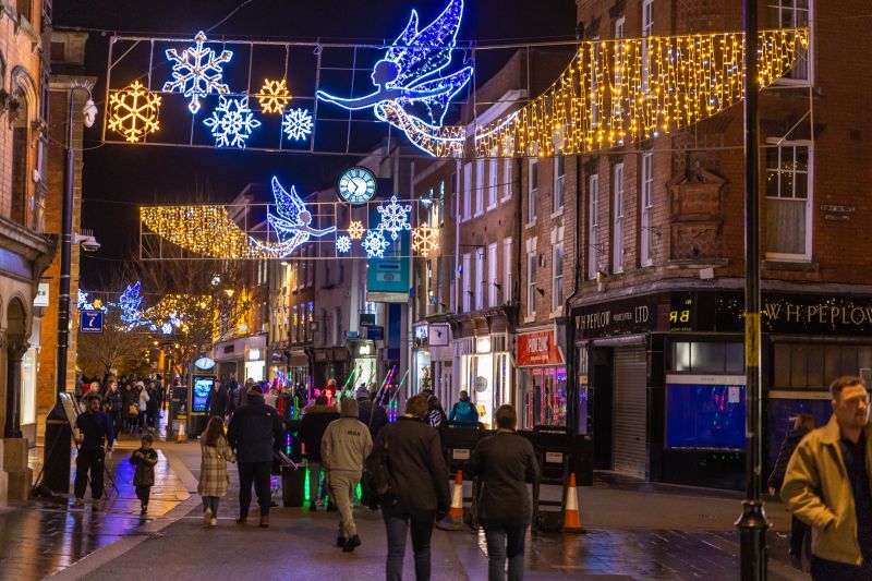 People walking under the Christmas lights in Worcester