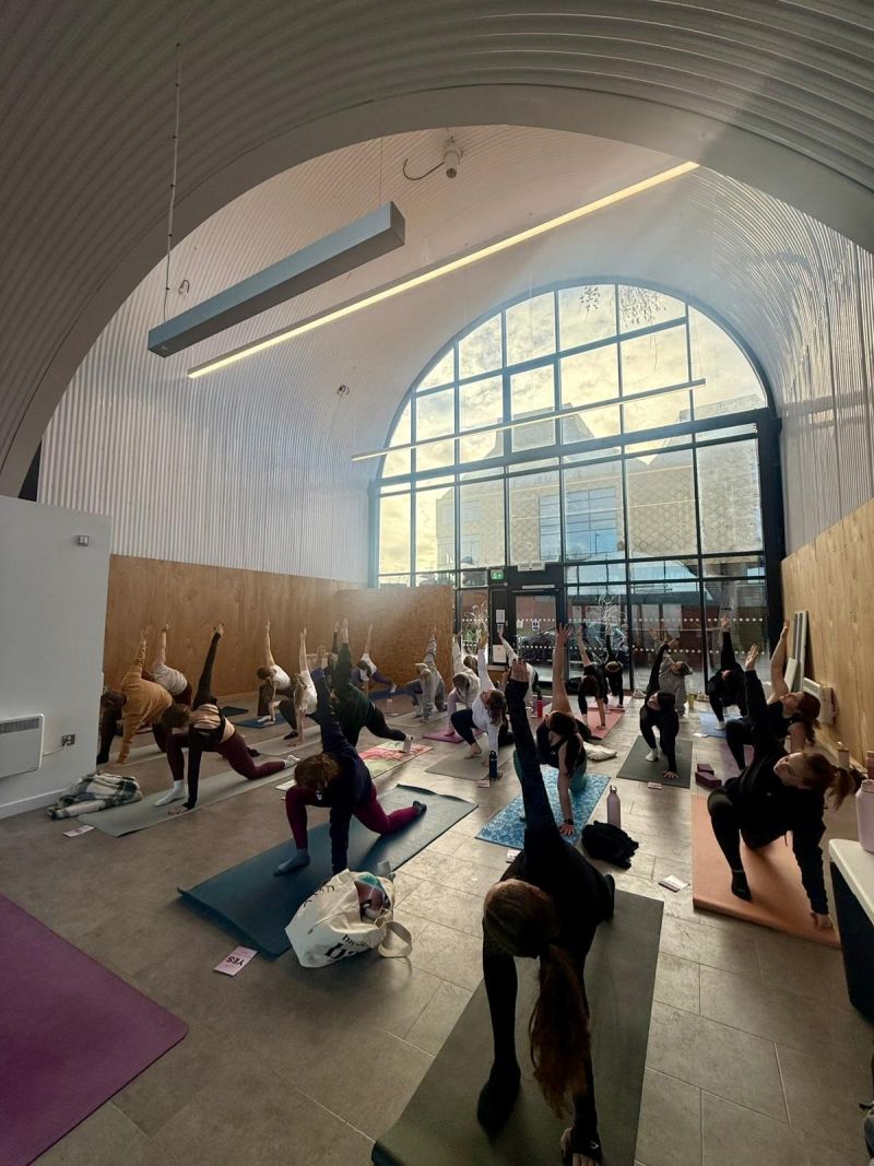 An exercise class taking place in a converted railway arch