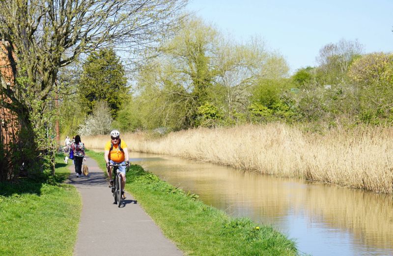 People cycling and walking on the canal footpath