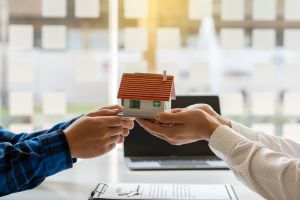 Two people holding a house to promote Renters’ Rights Act 2025