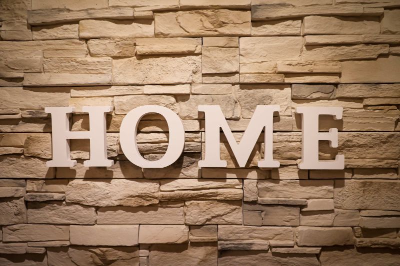 A sign saying 'home' showing on bricks