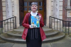 Councillor Lynn Denham standing outside the Guildhall, holding a copy of the Transforming Worcestershire proposal document